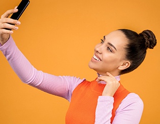 Woman taking selfie with cellphone