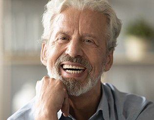 Middle-aged man showing off new dentures