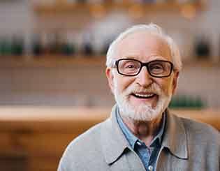 Man with glasses smiling at home